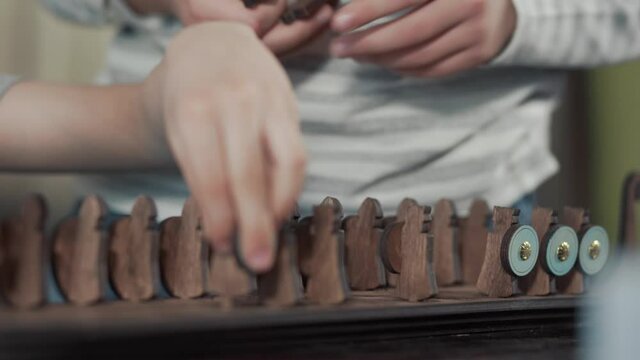 Close up children's hands that play an old board game