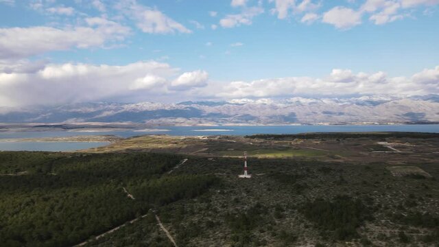 Panoramic aerial over protected natural forest with views over Adriatic Sea, mountains range Velebit and nearby islands in Zadar county, Croatia