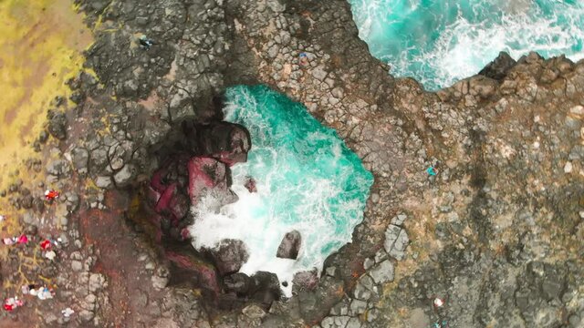 La Roche qui Pleure in Mauritius creates a illusion as surging waves recede on the cliff.