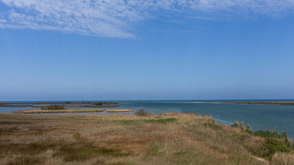 Plain coastal landscape with sea water and lakes and lagoons in Delta de l'Ebre, Catalonia