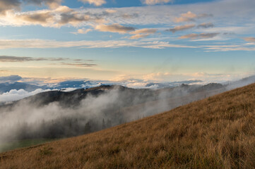 Evening in the mountains. Cloud level view. Evening landscape with clouds.