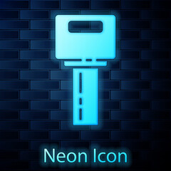 Glowing neon Car key with remote icon isolated on brick wall background. Car key and alarm system. Vector