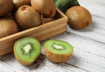Tasty kiwi on light wooden background