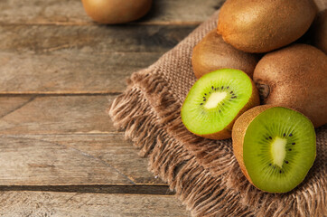 Tasty ripe kiwi on wooden background