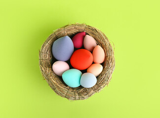 Nest with makeup sponges on color background
