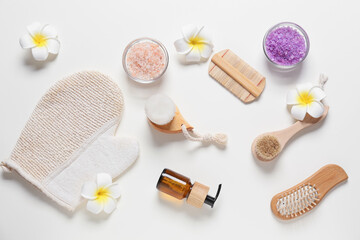 Composition with massage brushes and bath supplies on white background