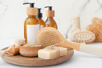 Composition with massage brushes and bath supplies on light background, closeup