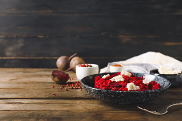 Plate with tasty beet risotto on wooden background