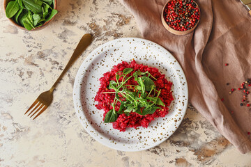 Plate with tasty beet risotto on grunge background