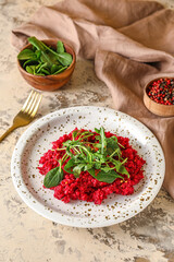 Plate with tasty beet risotto on grunge background