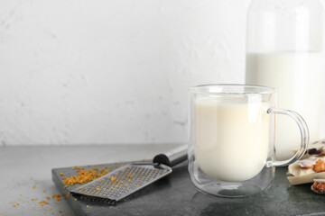 Cup with hot white chocolate on table