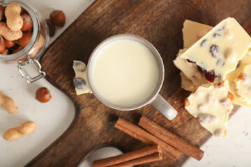 Cup with hot white chocolate on table
