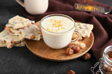 Cup with hot white chocolate on dark background