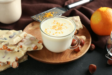 Cup with hot white chocolate on dark background