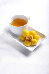 Nastar is pineapple tart cookies isolated on marble white background. Indonesian popular cookies during Eid Mubarak.