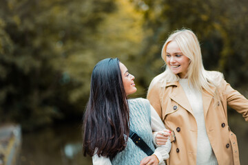 Fototapeta premium Two girls walking trough park and talking.