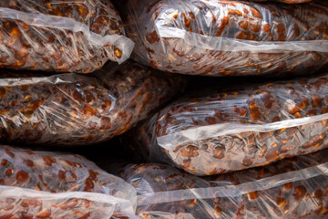 Ripe tamarind pulp has a sour taste. Used as a food seasoning to have a sour taste. Thai farmers unwrap sour tamarind together in a clear plastic bag for sale.