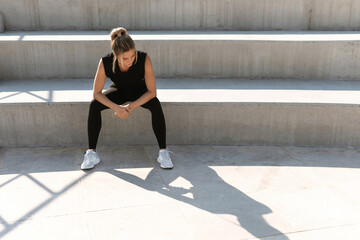 Young athletic woman and her shadow during summer workout