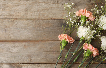 Fototapeta na wymiar Fresh carnation flowers on wooden background