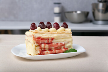 Piece of cake with vanilla cream, fruit syrup and berries. Close up.