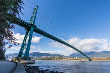 Lions Gate Bridge and Stanley Park Seawall in sunny day. Vancouver, British Columbia, Canada.