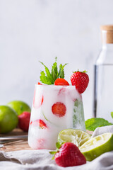 Tropical Caribbean cocktail mojito with coconut cream, strawberry and seltzer