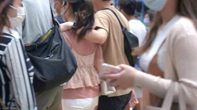 Slow motion of unrecognized people wearing medical face mask in Hong Kong. Coronavirus concept