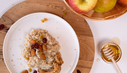 Liquid organic honey on a special spoon of honey in a bowl on a white background Close-up. Healthy food concept.
