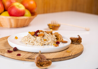 Liquid organic honey on a special spoon of honey in a bowl on a white background Close-up. Healthy food concept.
