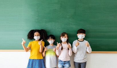 Diversity of children students wearing medical masks in the classroom