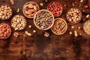 Nuts assortment. Various nuts in wooden bowls, shot from the top