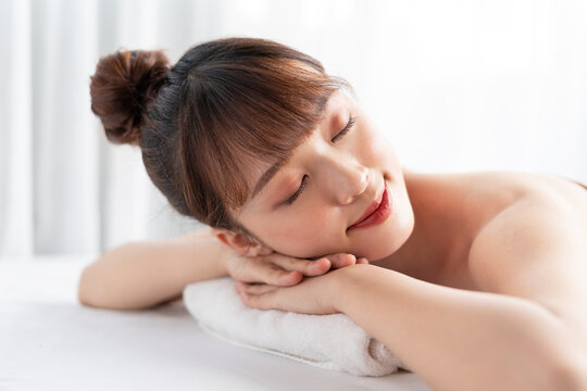 Young asian woman taking care of body at spa
