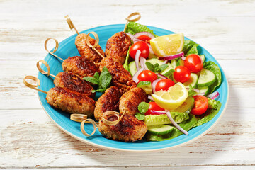 Lamb kofta kebabs with vegetables, top view