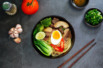 Fototapeta na wymiar Asian Noodle Soup beef, boiled spaghetti noodles, cooked egg, vegetables home made.