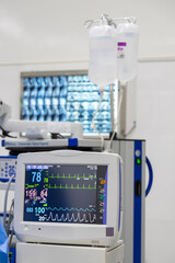 Vital sign monitoring screen inside modern operating room in hospital.The monitor shown heart rate ,blood pressure and graph of oxygen saturation for patient safety during surgery.