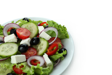 Plate of greek salad isolated on white background