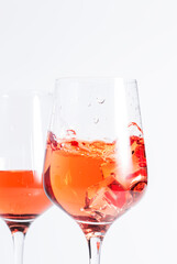 Rose wine glass with bottle on the white table. Rosado, rosato or blush wine tasting in wineshop, bar concept. Copy Space