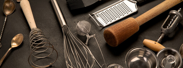 Set of kitchen utensils on black background. Tools for cooking.