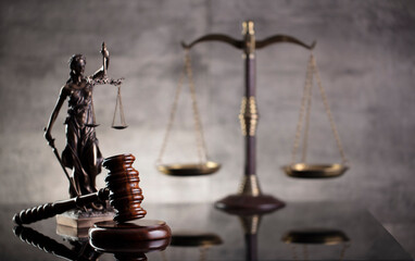 Law and justice concept. Law symbols composition: judge’s gavel, Themis  statue and scale. Gray background.