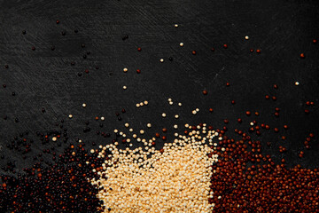 Set with different types of quinoa on dark background. Organic food concept.