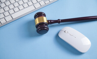 Judge gavel with a computer mouse and keyboard.
