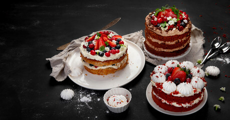 Assorted delicious and colorful homemade cakes with different type of filling on black background.
