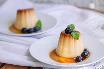 vanilla flan with blueberries on the white plate