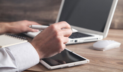 Graphic designer using tablet computer in office.