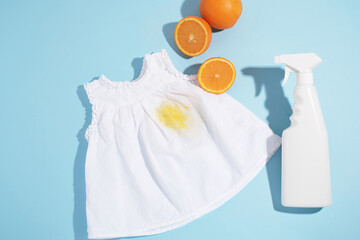 Juice stain on white clothes with stain remover. Isolated on a blue background. top view