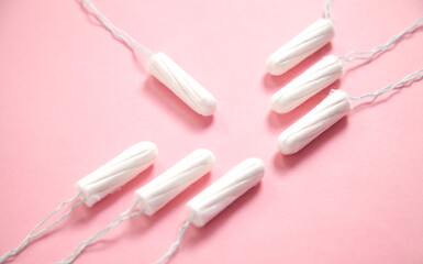 Menstrual tampon on a pink background.