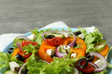 Plate of Greek salad and kitchen towel, close up