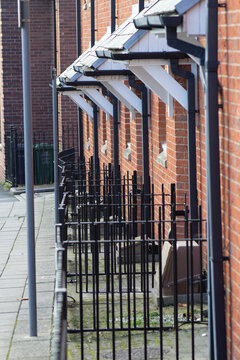 city railings next to the street with roofs and gutters