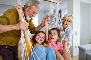 Grandchildren having fun at home while playing with their grandparents