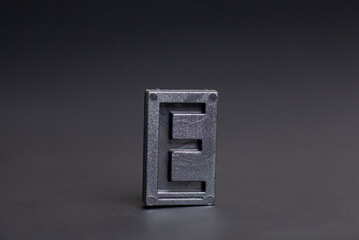 Letter Press E on black background